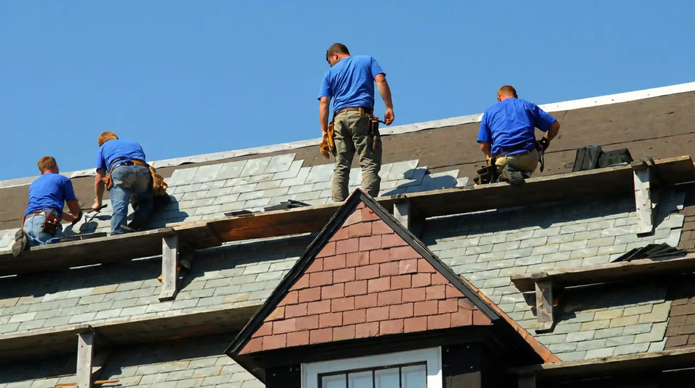 Roof replacement in progress with a team of professional contractors installing new shingles on a residential home in Springfield, MO